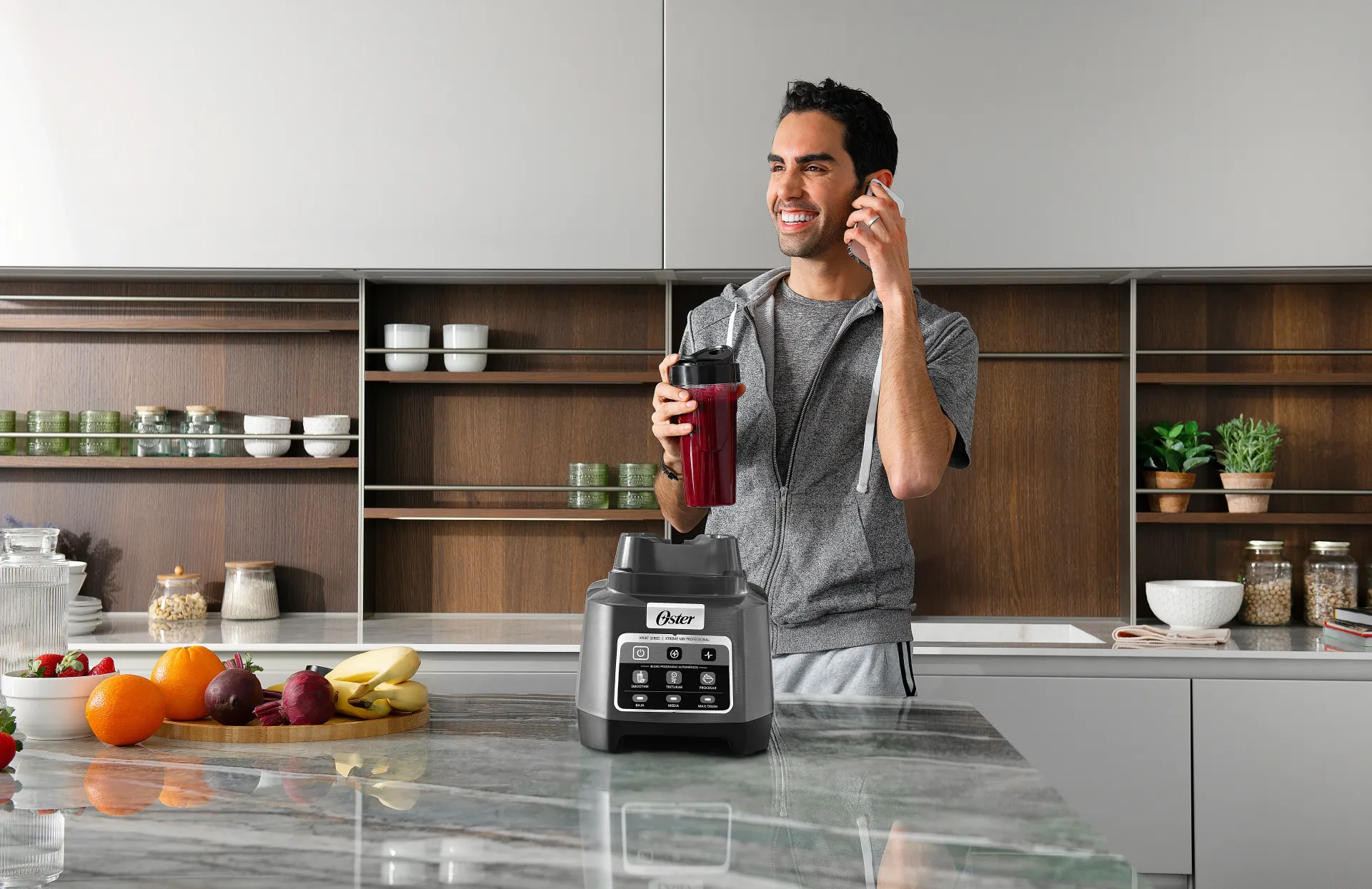 Man holding smoothie from Oster blender