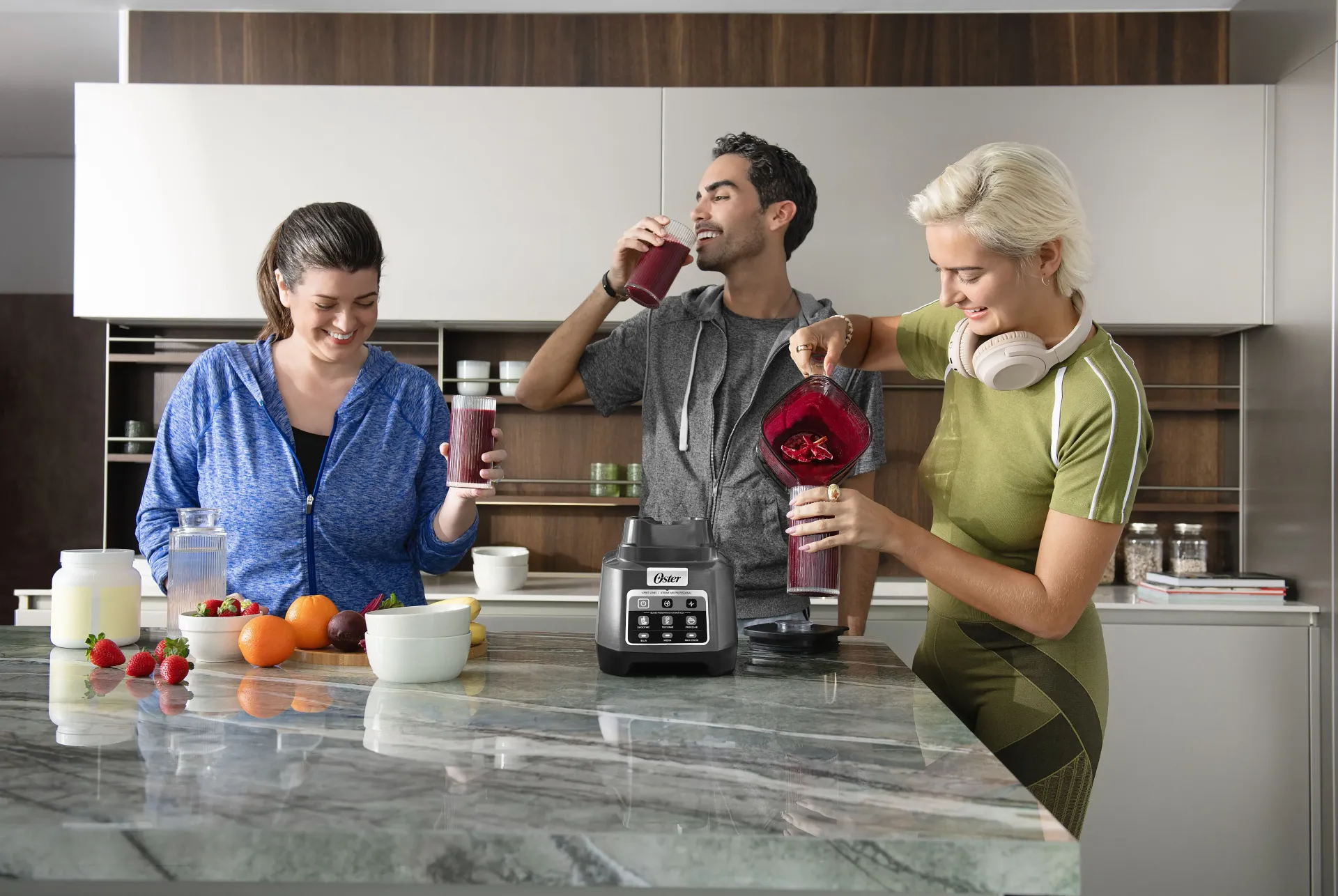Man adding ingredients to Oster blender